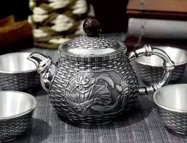 The silver teapot is a beautiful and expensive tea set