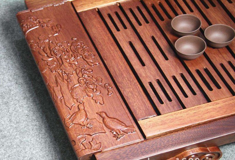A wooden tea tray with beautiful carving