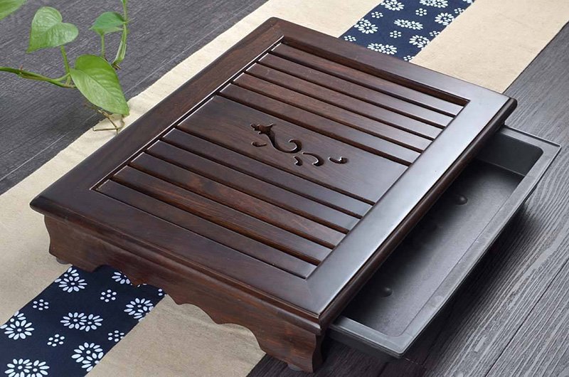 A wooden tea tray with drawer