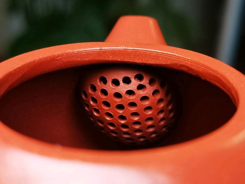 The tiny holes inside the teapot for filtration