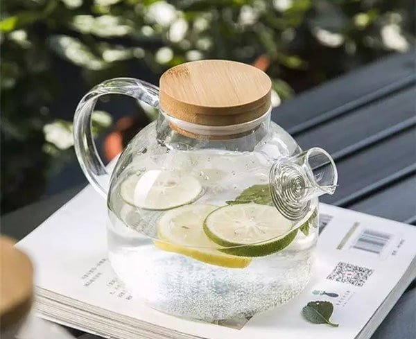 glass teapot with a wooden lid